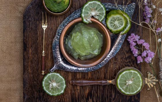 Traditional Thai dessert call candied kaffir lime on wooden background. Summer time, Selective Focus.