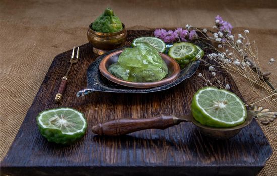 Traditional Thai dessert call candied kaffir lime on wooden background. Summer time, Selective Focus.