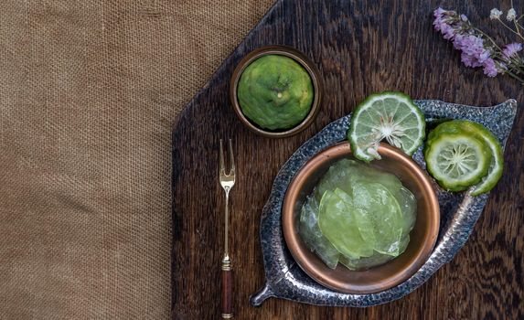 Traditional Thai dessert call candied kaffir lime on wooden background. Summer time, Selective Focus.