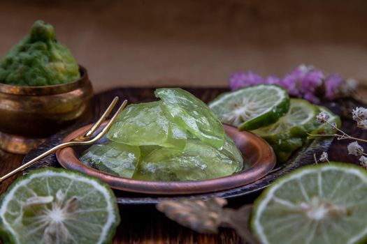 Traditional Thai dessert call candied kaffir lime on wooden background. Summer time, Selective Focus.