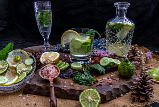 Cold water with lemon, kaffir lime, cucumber and mint leave on wooden background. Summer time, Healthy drink, vegetable juice, healthy food concept, Selective Focus.