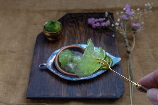 Traditional Thai dessert call candied kaffir lime on wooden background. Summer time, Selective Focus.
