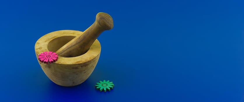 Wooden rustic style mortar and pestle. Spices and herb grinder over blue background with free space for text