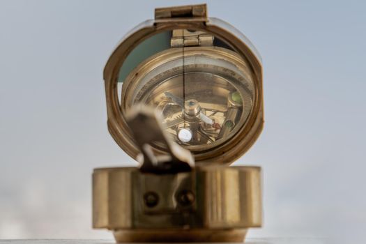 Antique bronze emblem compass (Old compass) Sky Background. Copy Space. Vintage Style