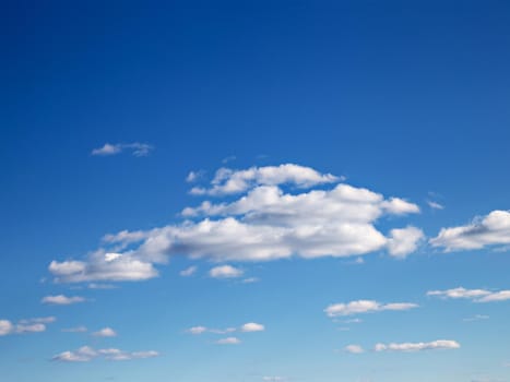 White clouds in blue skies on sunny spring day.