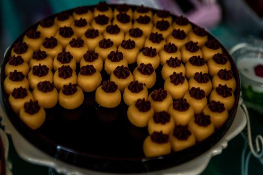 Traditional Thai Dessert (Kanom Thai) : Sanay Chan Made from minced coconut mixed with flour, sugar, egg yolk, rice flour and chan herb serving on a wooden background, Oblique view from the top.