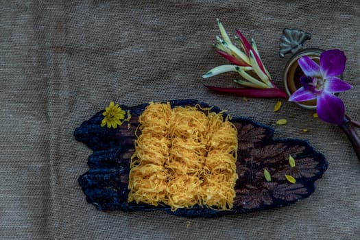 Traditional Thai desserts sweet and delicious : Golden egg strip is Thai desserts made from eggs on wooden background ( Thai name is Foi Thong).