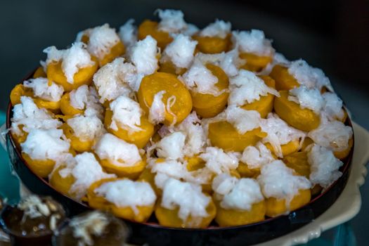 Traditional thai desserts, Khanom Hun Tra or Han tra, bean coated with egg serving on a wooden background.