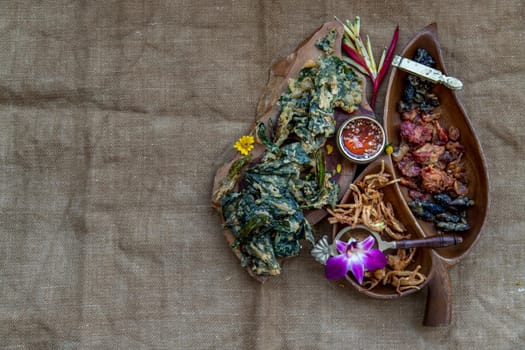 Crispy Flowers, Crispy Herbs and Crispy Vegetables served  with Sweet sauce in a Wooden tray, Top view, copy space.