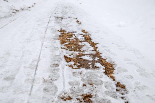 Sun warmed snowy road and bare ground appeared.
