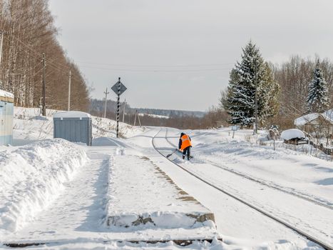 Railroad tracks and platform clears of snow.
