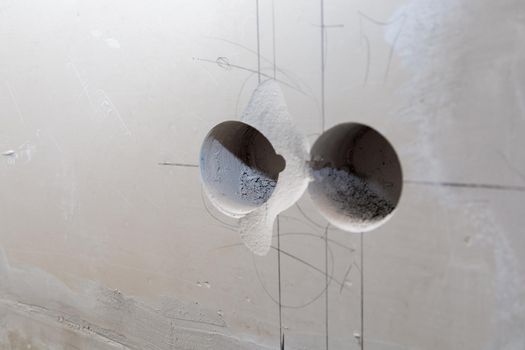 Holes in the wall for sockets. Electrical wiring in the wall. Repair, marking of sockets