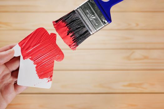 Symbol house painting brush in red color. New house remodeling renovation paint renew home. Painting work house icon renovation home construction model. Repair house decoration paint home improvement