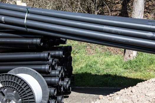 long black plastic pipes at a construction site