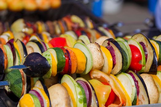 Vegetarian kebab from vegetables. On skewers zucchini, peppers, mushrooms.