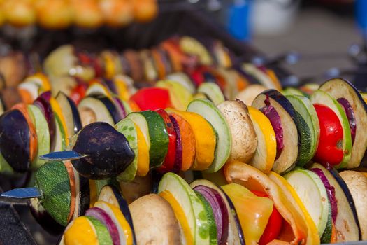 Vegetarian kebab from vegetables. On skewers zucchini, peppers, mushrooms.