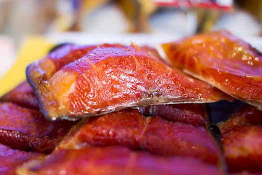 Chunks of red smoked fish.Dried fish at the fish market