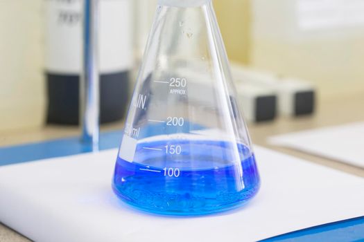 Flask with blue liquid in lab