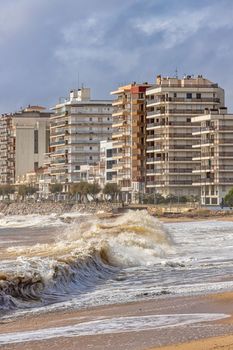 Powerful ocean wave breaking ina windy day in Spanish village Sant Antoni de Calonge in Costa Brava. Selective focus.