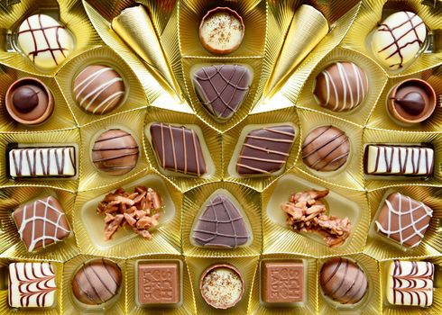 Selection of fine milk and dark chocolate belgian pralines, top view full frame background.