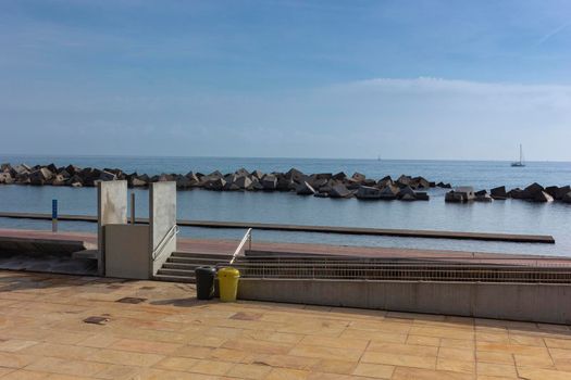 Saltwater pool in the Mediterranean Sea, in winter, without waves and a cloudy blue sky. November in Barcelona Spain.