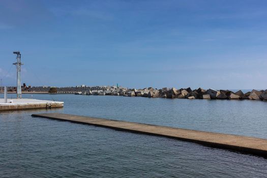 Saltwater pool in the Mediterranean Sea, in winter, without waves and a cloudy blue sky. November in Barcelona Spain.