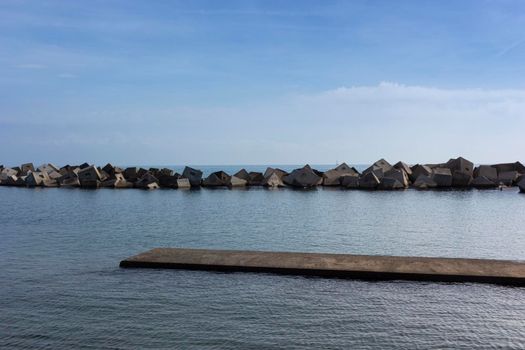 Saltwater pool in the Mediterranean Sea, in winter, without waves and a cloudy blue sky. November in Barcelona Spain.