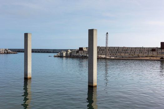 Saltwater pool in the Mediterranean Sea, in winter, without waves and a cloudy blue sky. November in Barcelona Spain.