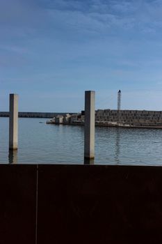 Saltwater pool in the Mediterranean Sea, in winter, without waves and a cloudy blue sky. November in Barcelona Spain.