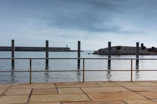 Saltwater pool in the Mediterranean Sea, in winter, without waves and a cloudy blue sky. November in Barcelona Spain.