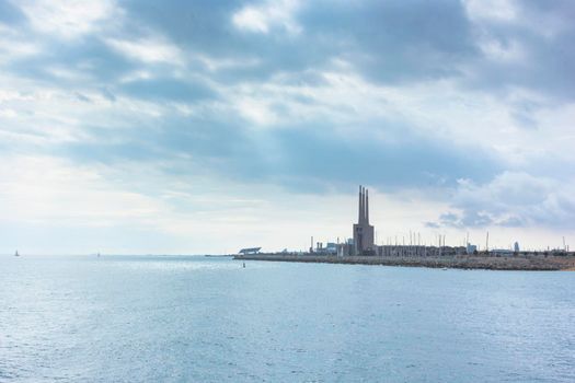 Seascape in the Mediterranean Sea with views of an old disused Thermal Power Plant for the production of electricity in Barcelona