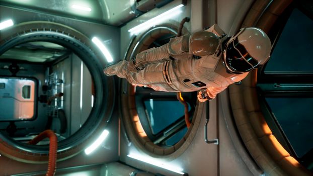 An astronaut in zero gravity checks the module of his spaceship. View of the spacecraft with an astronaut.