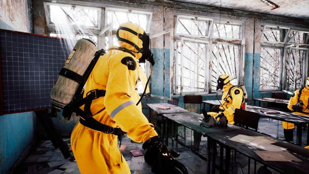 The last survivors of a nuclear war or a deadly viral pandemic discuss a roadmap in an abandoned school. Post-apocalyptic world concept. View of an abandoned apocalyptic building.