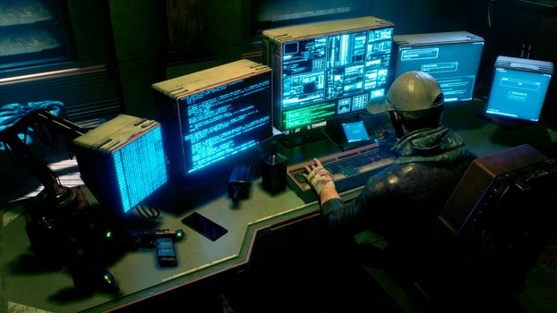 A male hacker surrounded by glowing monitors hacks into someone else's computer network in a dark room of his office. A view of the hacker's futuristic computer office.