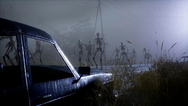 Spooky scary skeletons are walking along a misty abandoned apocalyptic road. View of an abandoned mystic foggy landscape.