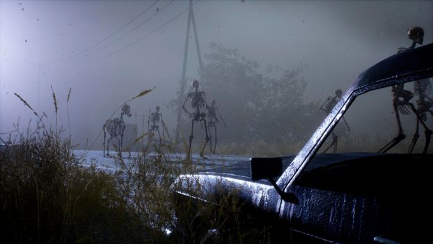 Spooky scary skeletons are walking along a misty abandoned apocalyptic road. View of an abandoned mystic foggy landscape.