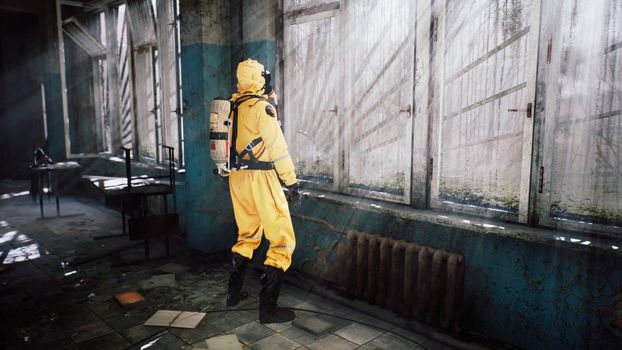 The last survivor of a nuclear war or a deadly viral pandemic stands in the morning at the window in a destroyed building. Post-apocalyptic world concept. View of an abandoned apocalyptic building.