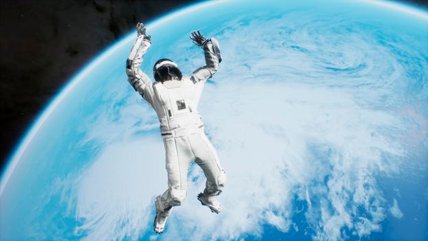 An astronaut is flying in outer space and falls on an unknown blue planet.