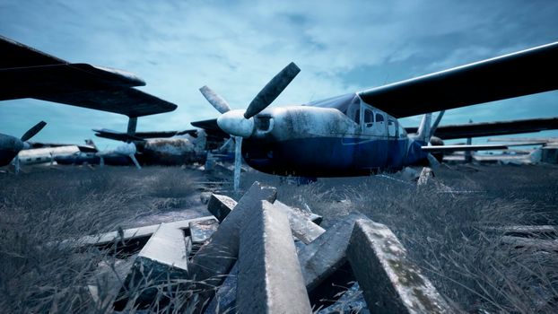 Abandoned and destroyed planes are in the field. A lot of rusty, forgotten and broken planes.