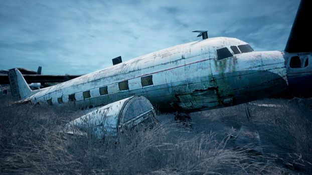 Rusty and broken planes stand in a field against a hazy blue sky. A lot of destroyed, destroyed, abandoned planes.