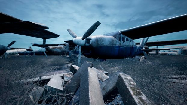 Rusty and broken planes stand in a field against a hazy blue sky. A lot of destroyed, destroyed, abandoned planes.