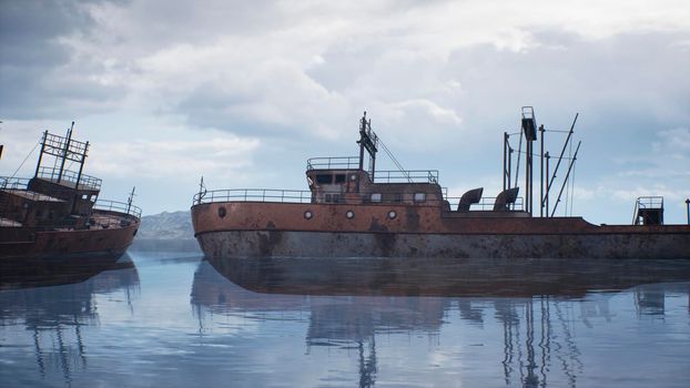 Rusty abandoned ships in the sea bay. Destroyed abandoned industrial ships.