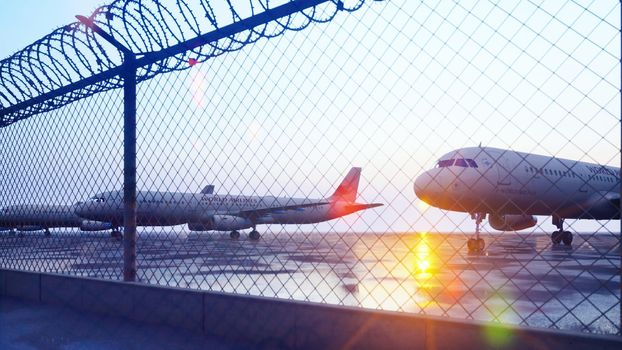 Commercial aircraft at the airport are waiting for departure.