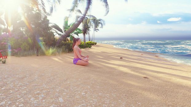 Beautiful young woman performing a spiritual yoga pose on the ocean shore at sunrise. A woman in the Lotus position is sitting on the beach. The concept of calmness and meditation. Harmony and balance.