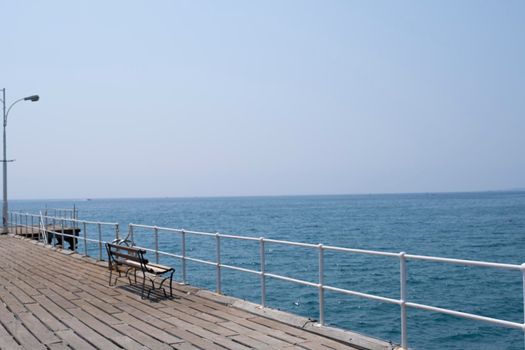 Various flags fluttering in the wind in the morning on the pier in the ancient Greek city of Limassol.