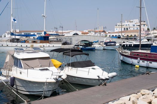 Large sailing boats and yachts on the pier on a clear Sunny day.