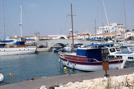 Large sailing boats and yachts on the pier on a clear Sunny day.