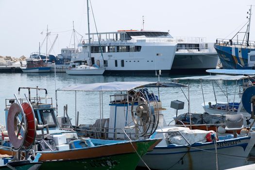 Large sailing boats and yachts on the pier on a clear Sunny day.