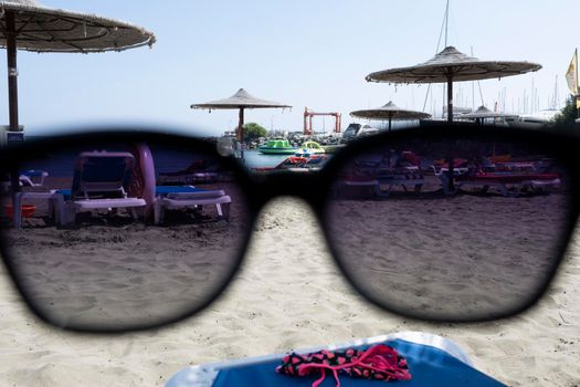 View of the Sunny beach through sunglasses.