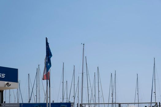 Large sailing boats and yachts on the pier on a clear Sunny day.